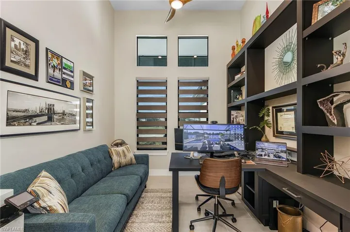 Office with light tile patterned floors and built in features