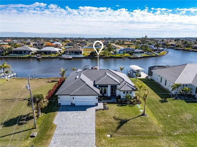 Birds eye view of property with a water view