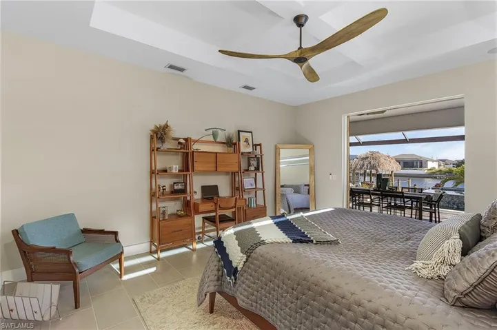 Bedroom featuring light tile patterned floors and ceiling fan
