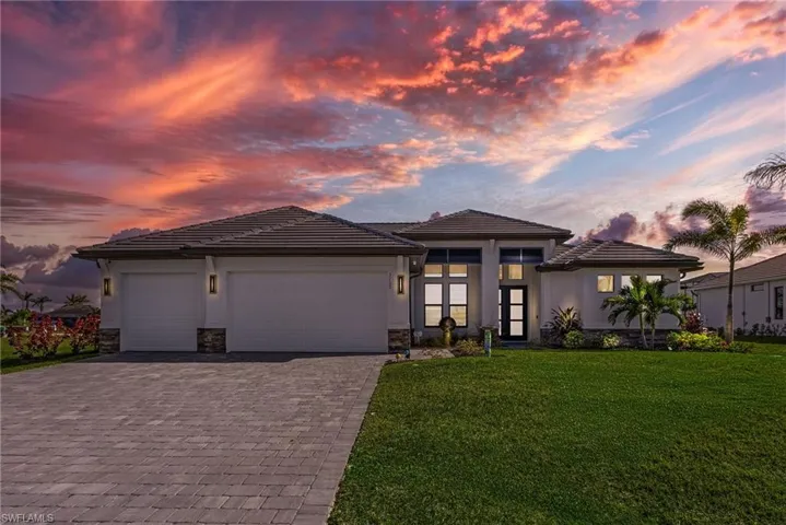 Prairie-style house featuring a garage and a yard