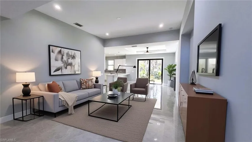 Virtual staging. Living room with light marble finish floors and recessed lighting