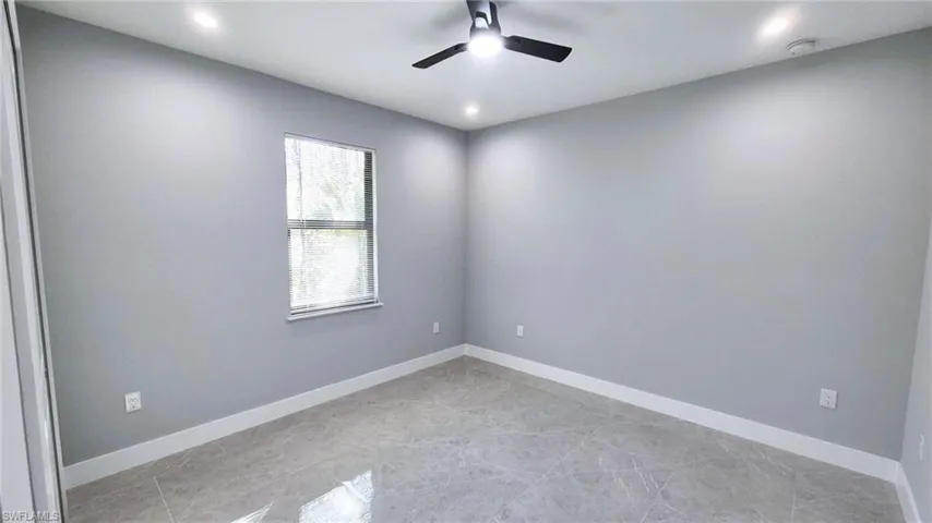 Empty room with recessed lighting and ceiling fan