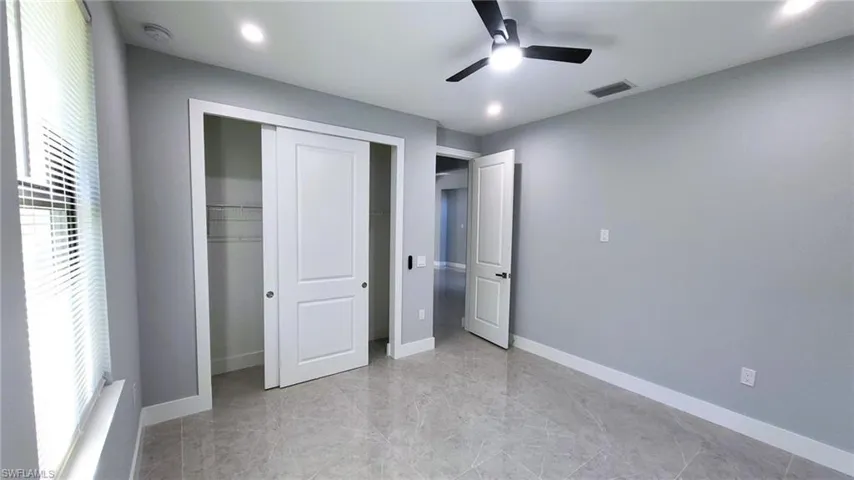 Unfurnished bedroom with a closet, ceiling fan, and recessed lighting
