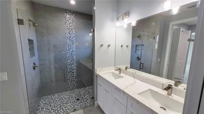 Bathroom with a stall shower and double vanity