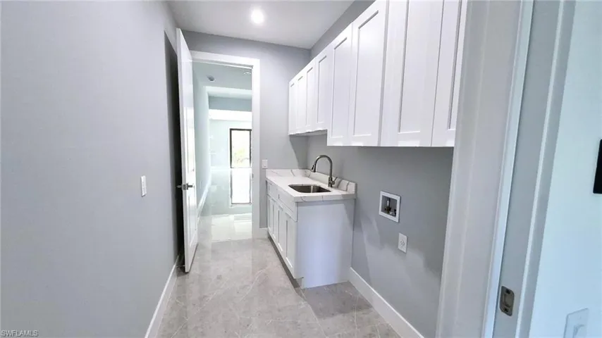 Laundry area featuring cabinet space and hookup for a washing machine