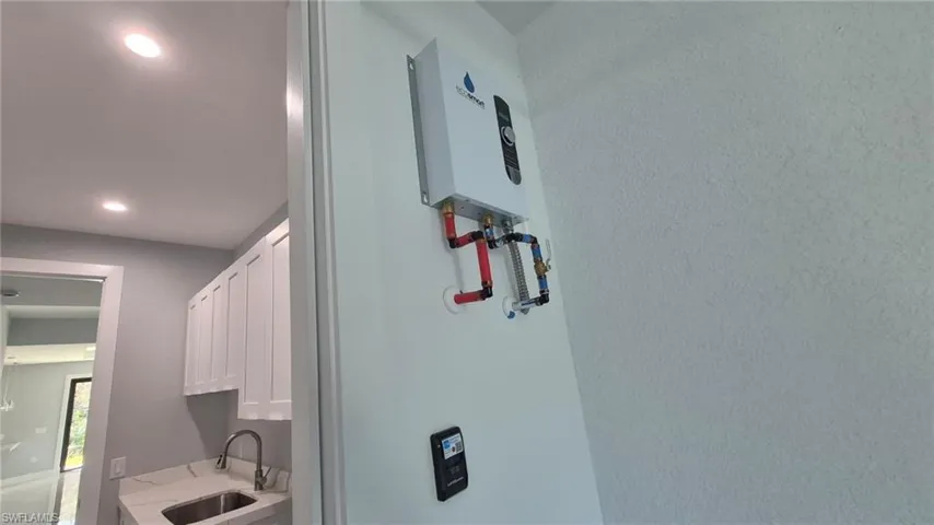 Detailed view of recessed lighting and tankless water heater
