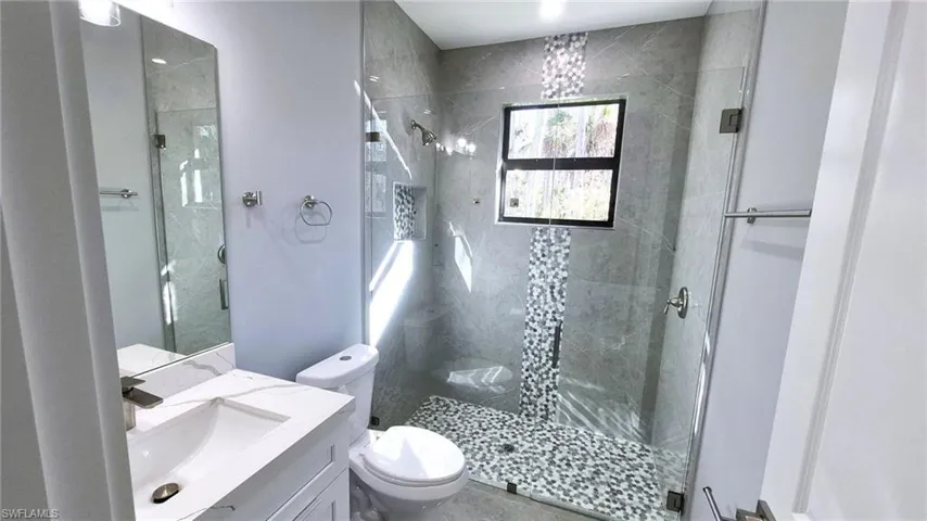 Full bath with vanity and a shower stall