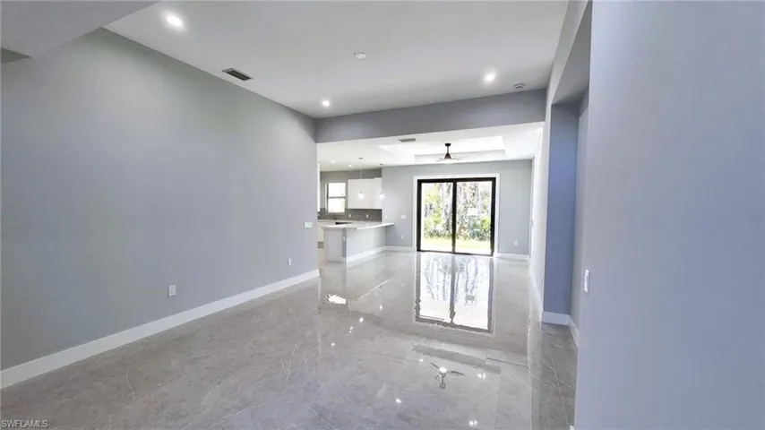 Unfurnished room with light marble finish floors and recessed lighting