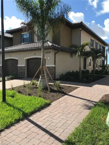 Mediterranean / spanish-style house featuring stone siding, stucco siding, and a tiled roof