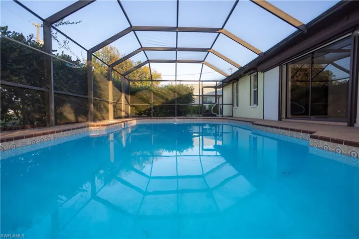 View of pool featuring glass enclosure