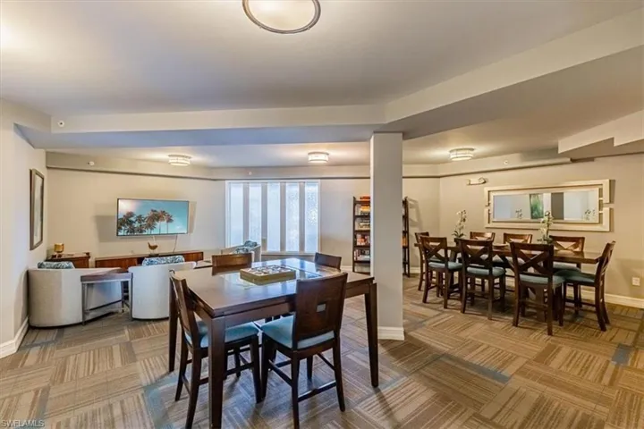 Carpeted dining space with baseboards