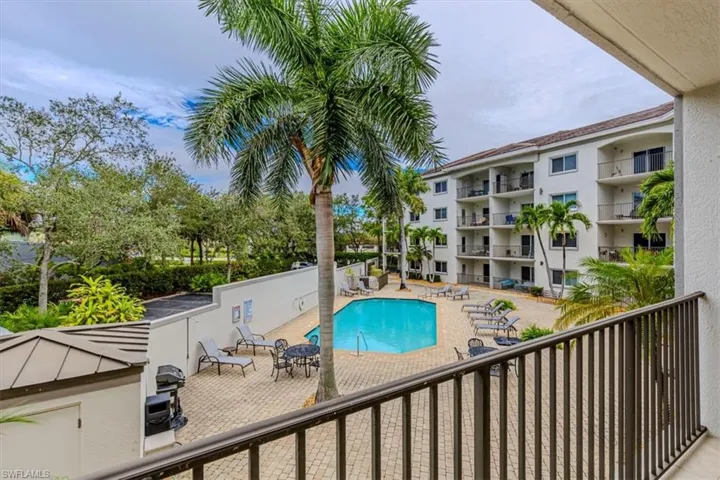 Community pool with a patio and a balcony