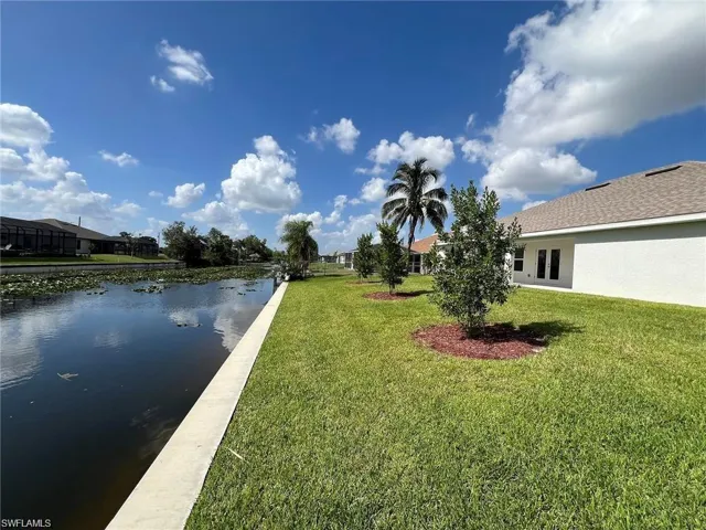 View of green lawn with a water view