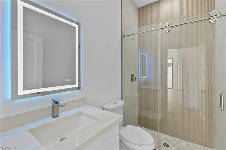 Full bathroom featuring a shower stall and vanity