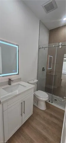 Corridor featuring light wood finished floors and recessed lighting