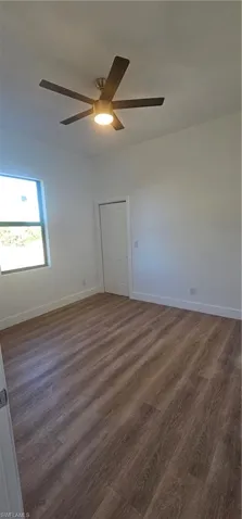 Bathroom with vanity, a shower stall, and light wood-style flooring