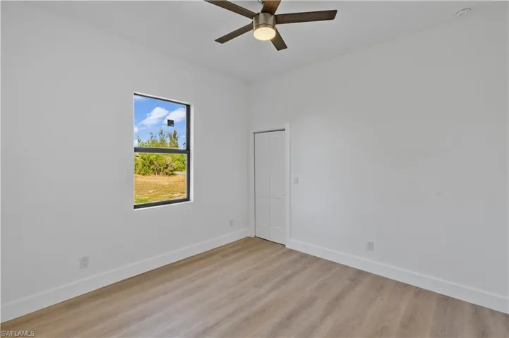 Spare room with light wood-style flooring and ceiling fan
