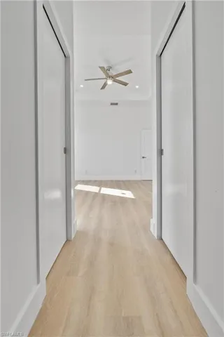 Hall with recessed lighting and light wood-style floors
