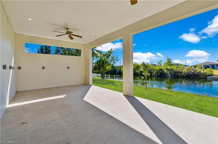 View of patio / terrace featuring ceiling fan and a water view
