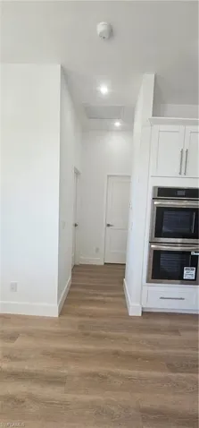 Full bathroom with a stall shower, light wood finished floors, and recessed lighting