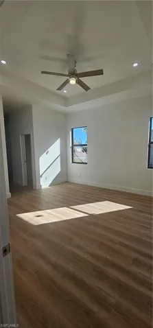 Garage with electric water heater, a garage door opener, electric panel, and recessed lighting