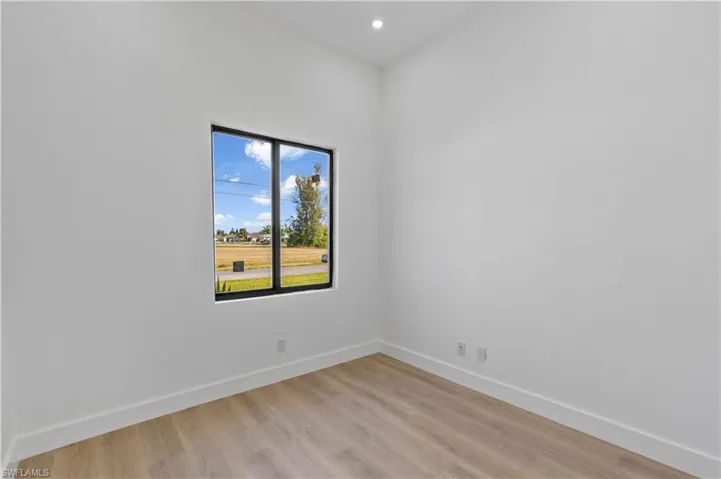 Spare room featuring light wood finished floors and recessed lighting