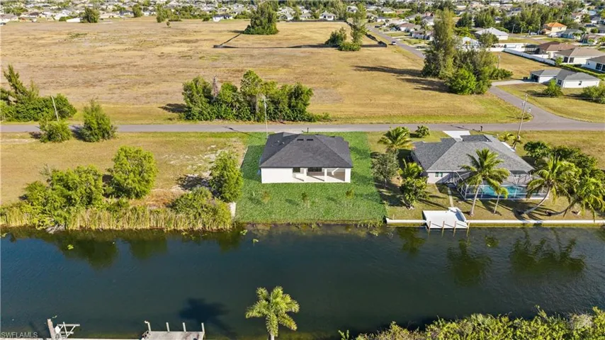 Aerial perspective of suburban area with a large body of water