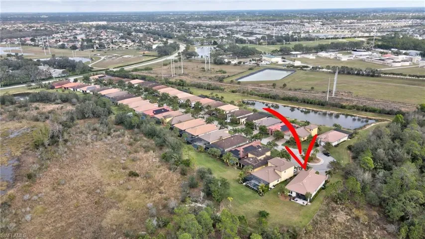 View of property location with a nearby body of water and nearby suburban area