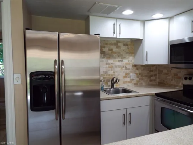 Kitchen has Corian counters