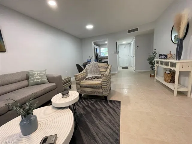Living area featuring light tile patterned floors and recessed lighting