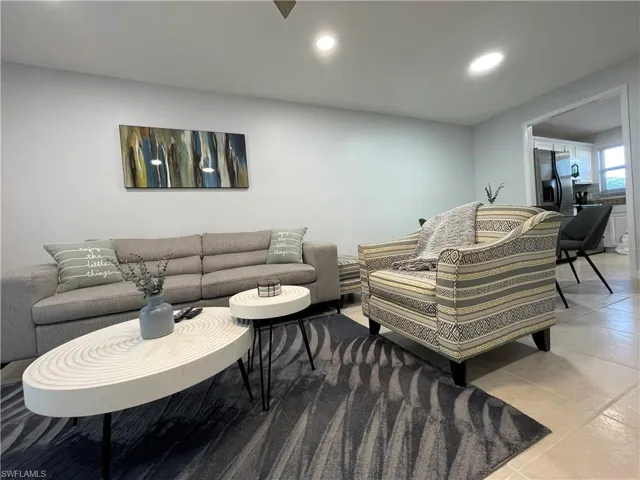 Living area featuring recessed lighting and light tile patterned floors