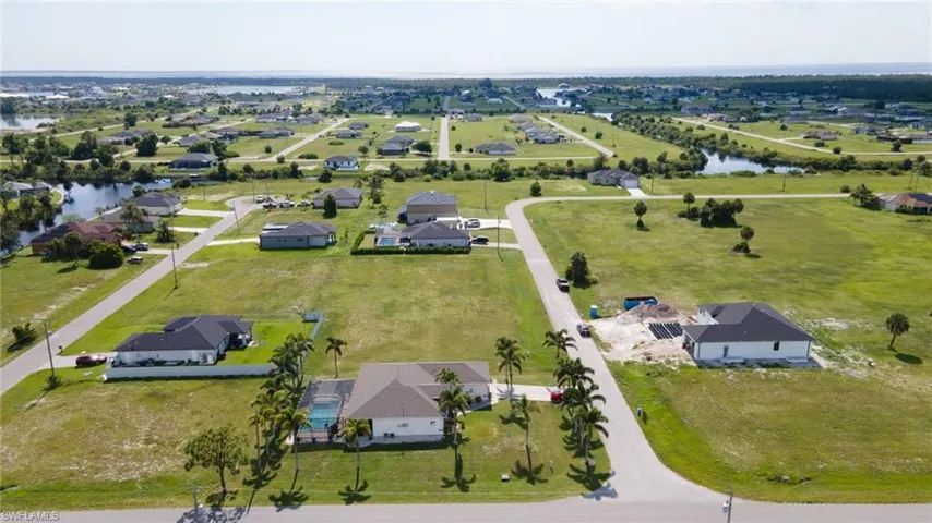 Aerial perspective of suburban area with a nearby body of water