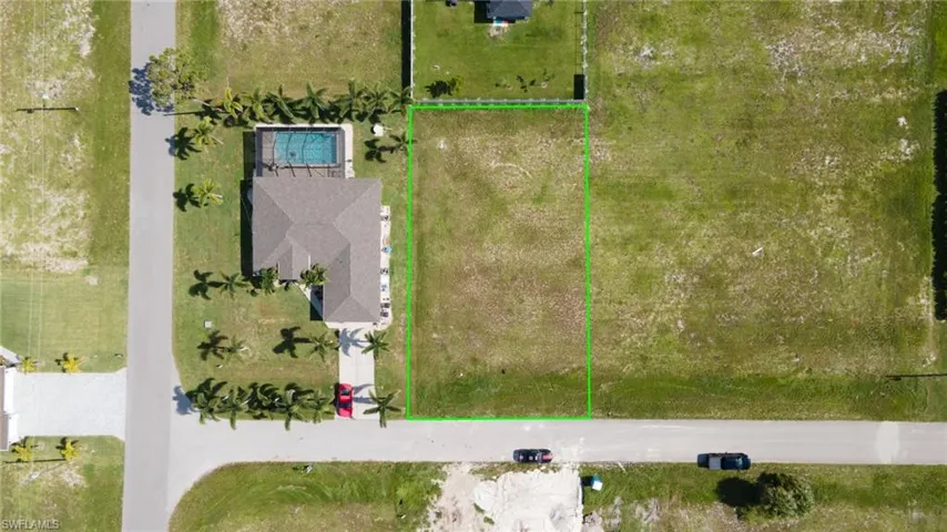 Aerial view of property and surrounding area featuring property boundaries highlighted