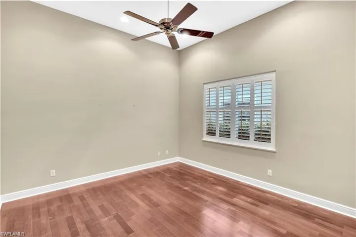 Spare room featuring ceiling fan and hardwood / wood-style floors