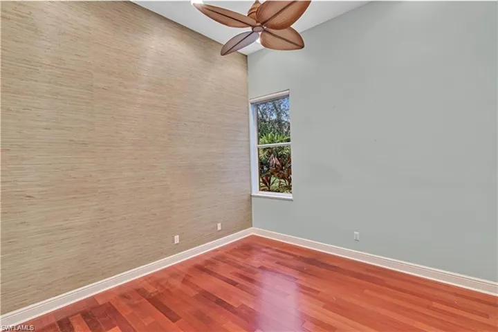 Unfurnished room with hardwood / wood-style floors and ceiling fan
