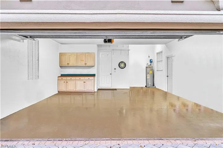 Garage with a garage door opener and water heater