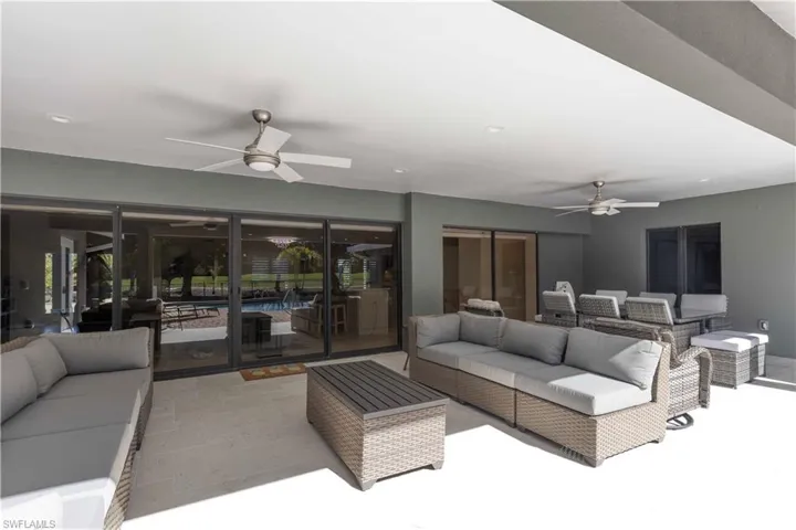 Living area featuring a sunroom, a ceiling fan, and recessed lighting