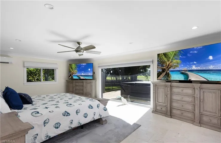 Bedroom featuring access to exterior, recessed lighting, a ceiling fan, an AC wall unit, and stone finish floor