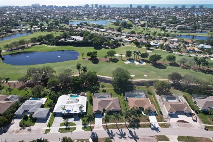 Birds eye view of property featuring view of golf course, a water view, and a residential view