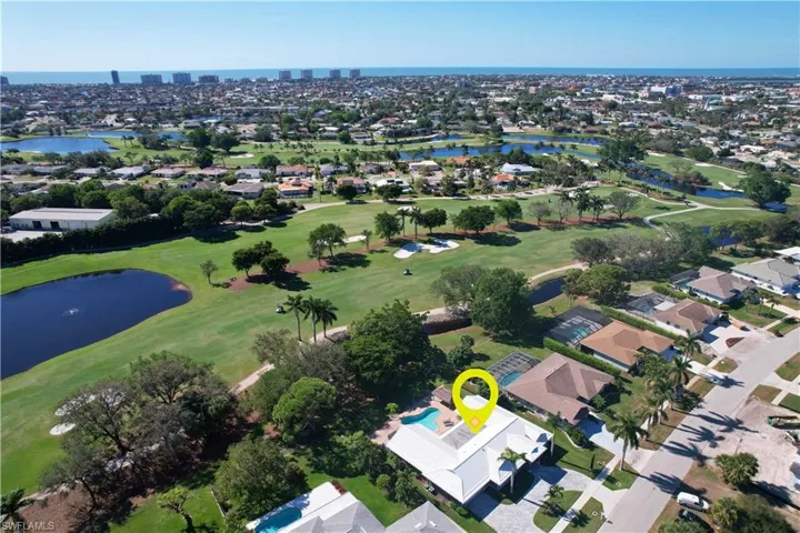 Birds eye view of property with a water view and golf course view