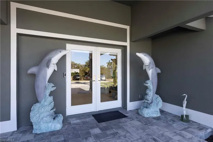 Property entrance featuring french doors and stucco siding