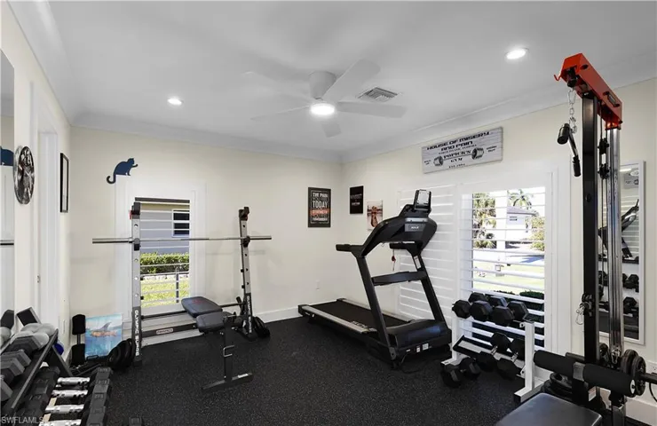 Workout area featuring visible vents, baseboards, a ceiling fan, ornamental molding, and recessed lighting