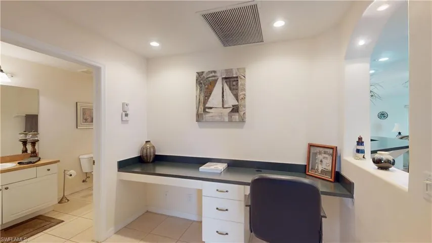 Tiled office featuring built in desk and sink