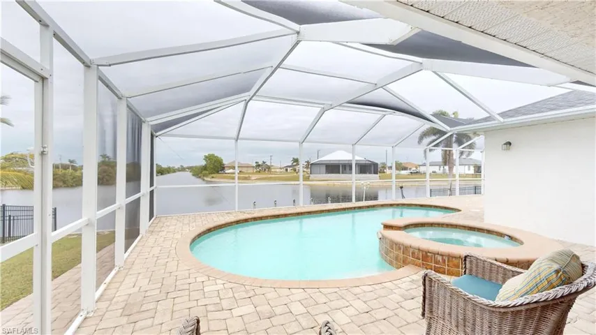 View of pool with a lanai, an in ground hot tub, and a patio