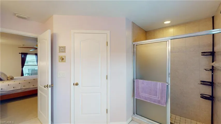 Bathroom with ceiling fan and walk in shower