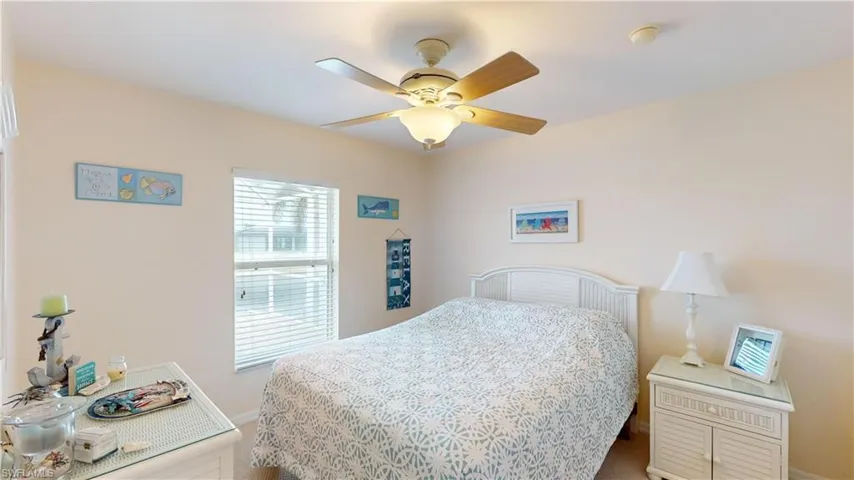 Bedroom featuring ceiling fan and carpet floors