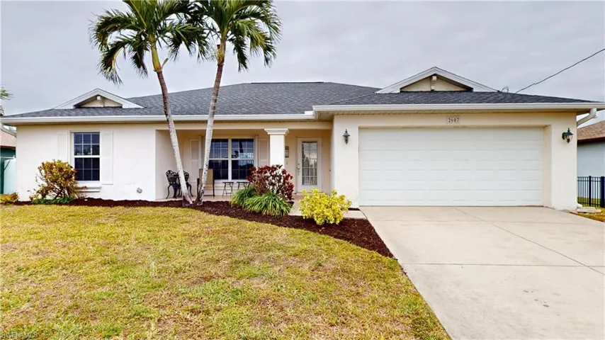 Single story home with a front yard and a garage