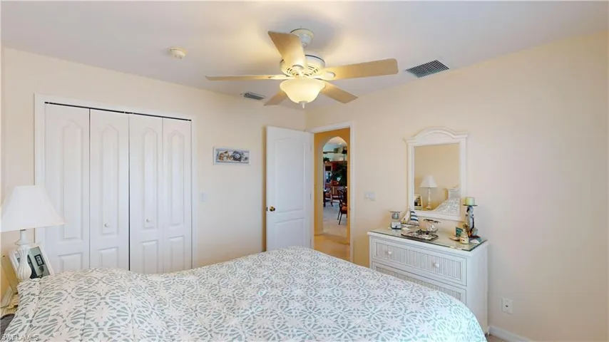Bedroom with ceiling fan and a closet