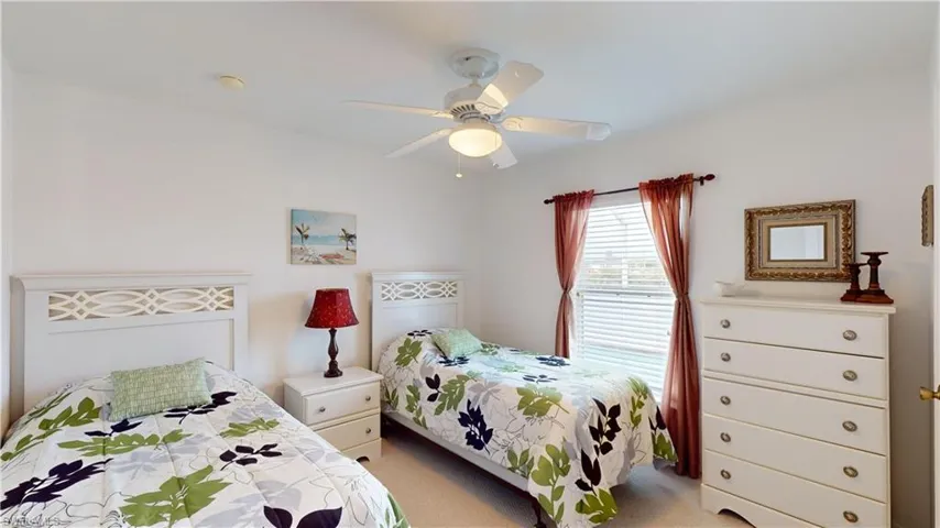Bedroom featuring ceiling fan and light carpet
