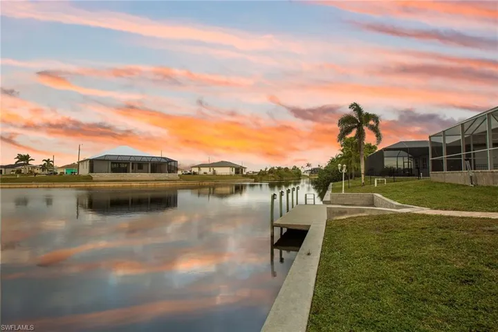 Dock area featuring a yard and a water view